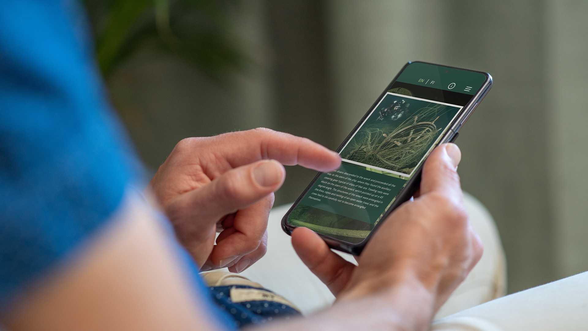 Person browsing the exhibition on their phone